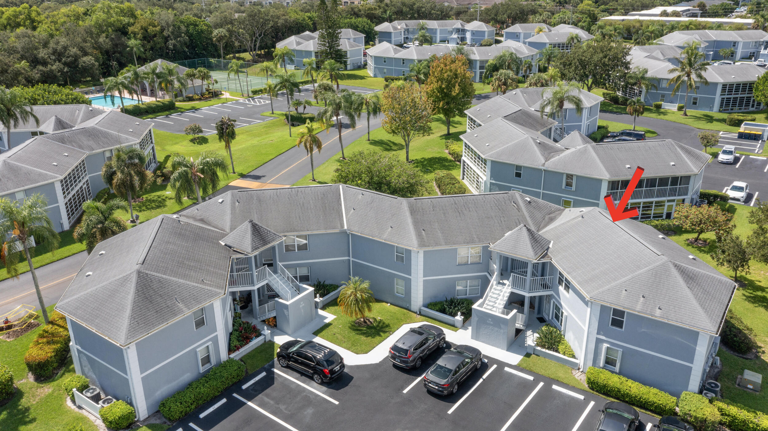 3236 Southeast Aster Lane, Unit M228 Stuart, FL 34994 - Photo 41 of 51 an aerial view of multiple houses with yard