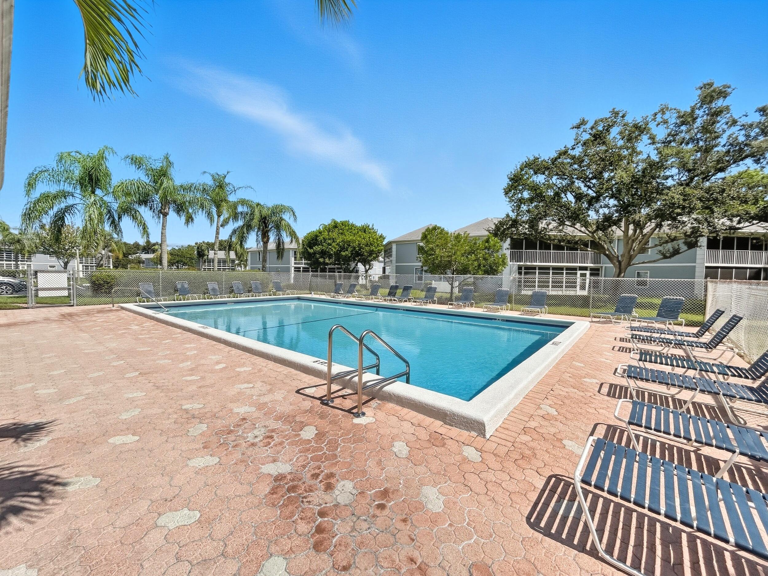 3236 Southeast Aster Lane, Unit M228 Stuart, FL 34994 - Photo 42 of 51 a view of swimming pool with a lounge chair