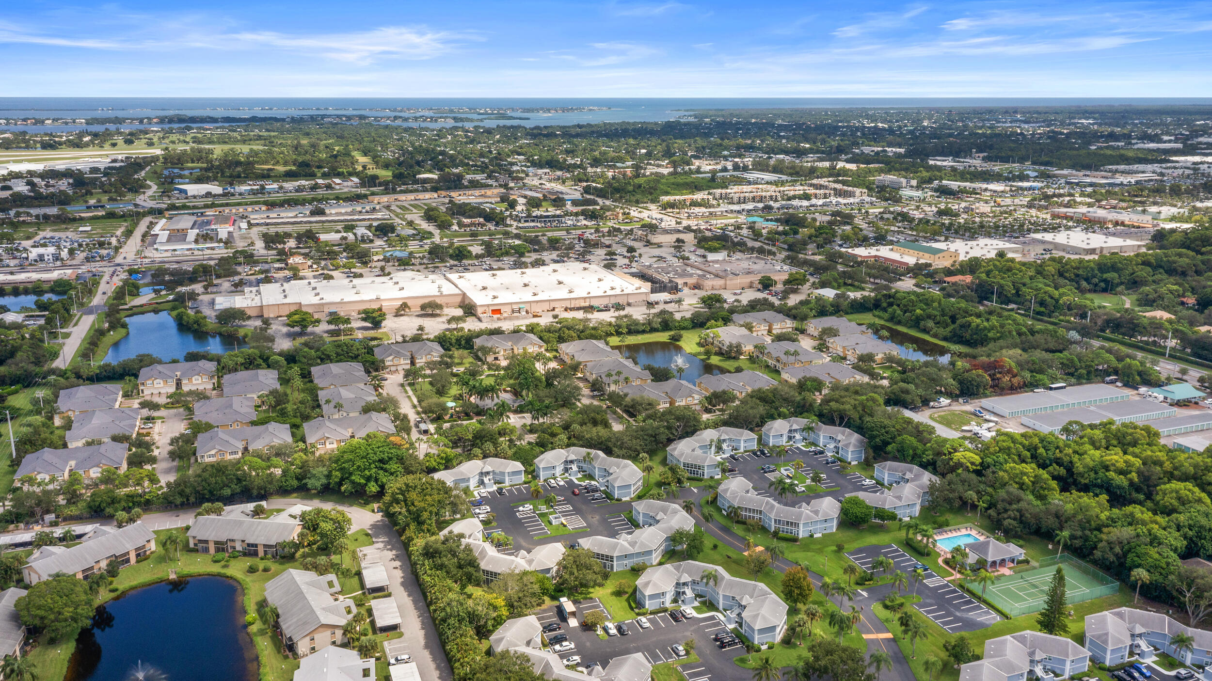 3236 Southeast Aster Lane, Unit M228 Stuart, FL 34994 - Photo 47 of 51 an aerial view of residential building with parking space