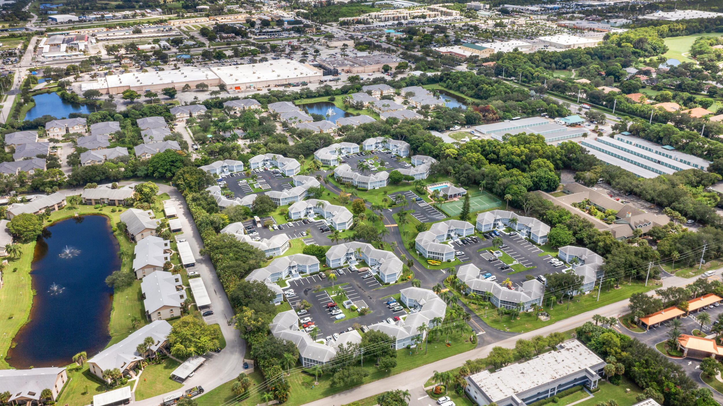 3236 Southeast Aster Lane, Unit M228 Stuart, FL 34994 - Photo 48 of 51 an aerial view of residential houses with outdoor space