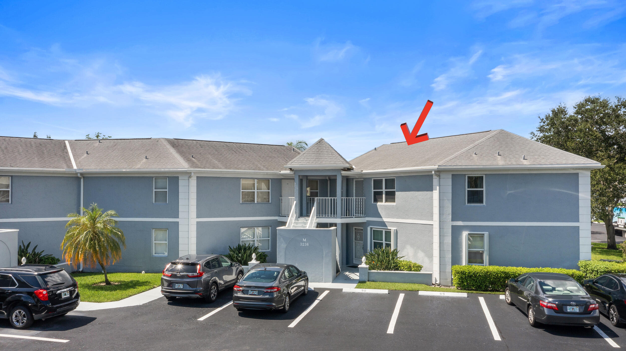 3236 Southeast Aster Lane, Unit M228 Stuart, FL 34994 - Photo 8 of 51 a car parked in front of a house