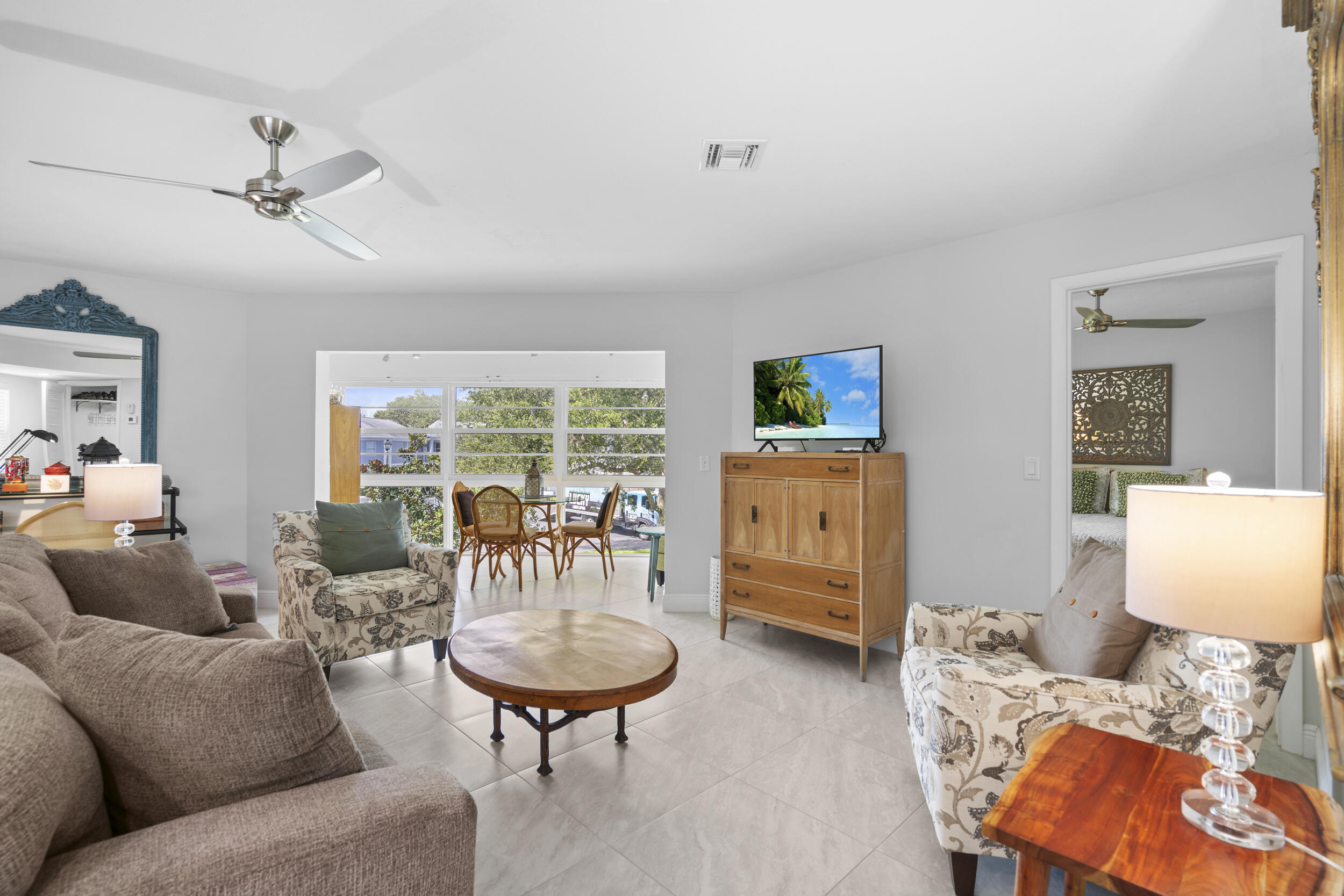 3236 Southeast Aster Lane, Unit M228 Stuart, FL 34994 - Photo 10 of 51 a living room with furniture and a large window