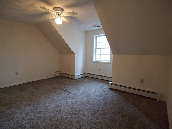 107 Nashua Road Pepperell, MA 01463 - Photo 12 of 22 an empty room with windows and fan