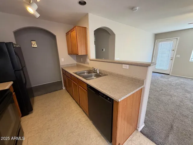a kitchen with a sink a refrigerator and a stove