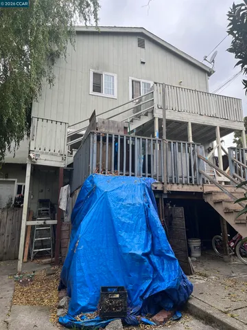 a view of roof deck with wooden floor and fence