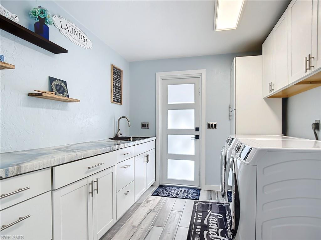 15711 Anderson Lane Fort Myers, FL 33912 - Photo 17 of 48 Laundry room with designer concrete countertop, lots of cabinet space, for washing machine and clothes dryer