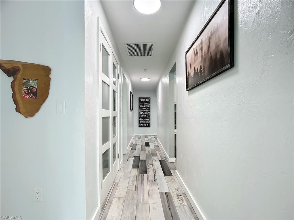 15711 Anderson Lane Fort Myers, FL 33912 - Photo 18 of 48 Downstairs Hallway with doors to kitchen pantry