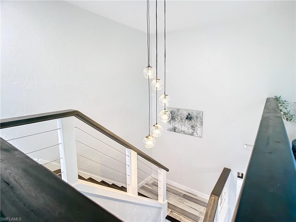 15711 Anderson Lane Fort Myers, FL 33912 - Photo 19 of 48 Stairs to 2nd level with wood bannister and wood finished steps