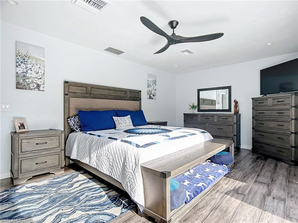 15711 Anderson Lane Fort Myers, FL 33912 - Photo 23 of 48 Primary Bedroom featuring designer ceiling fan, bamboo floors, and recessed lighting