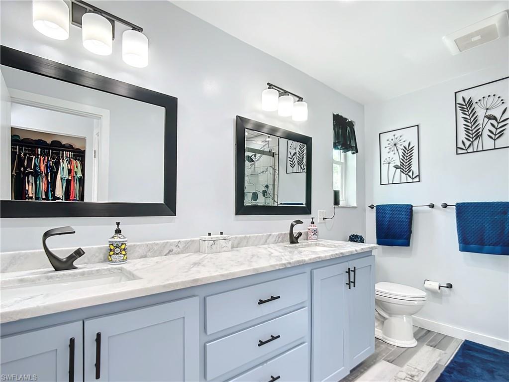 15711 Anderson Lane Fort Myers, FL 33912 - Photo 29 of 48 Primary Bathroom featuring a spacious linen closet, double vanity, and designer faucets