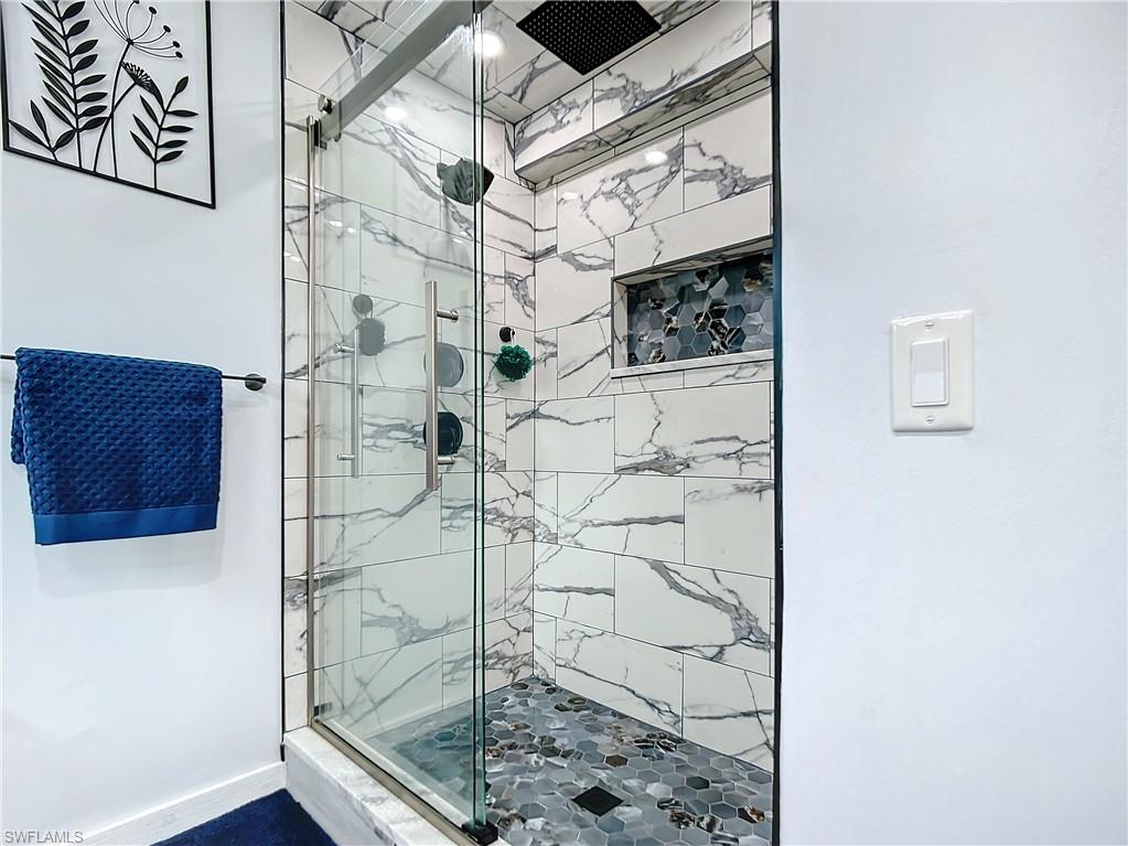 15711 Anderson Lane Fort Myers, FL 33912 - Photo 30 of 48 Primary Bathroom with a designer tile shower and multiple shower heads