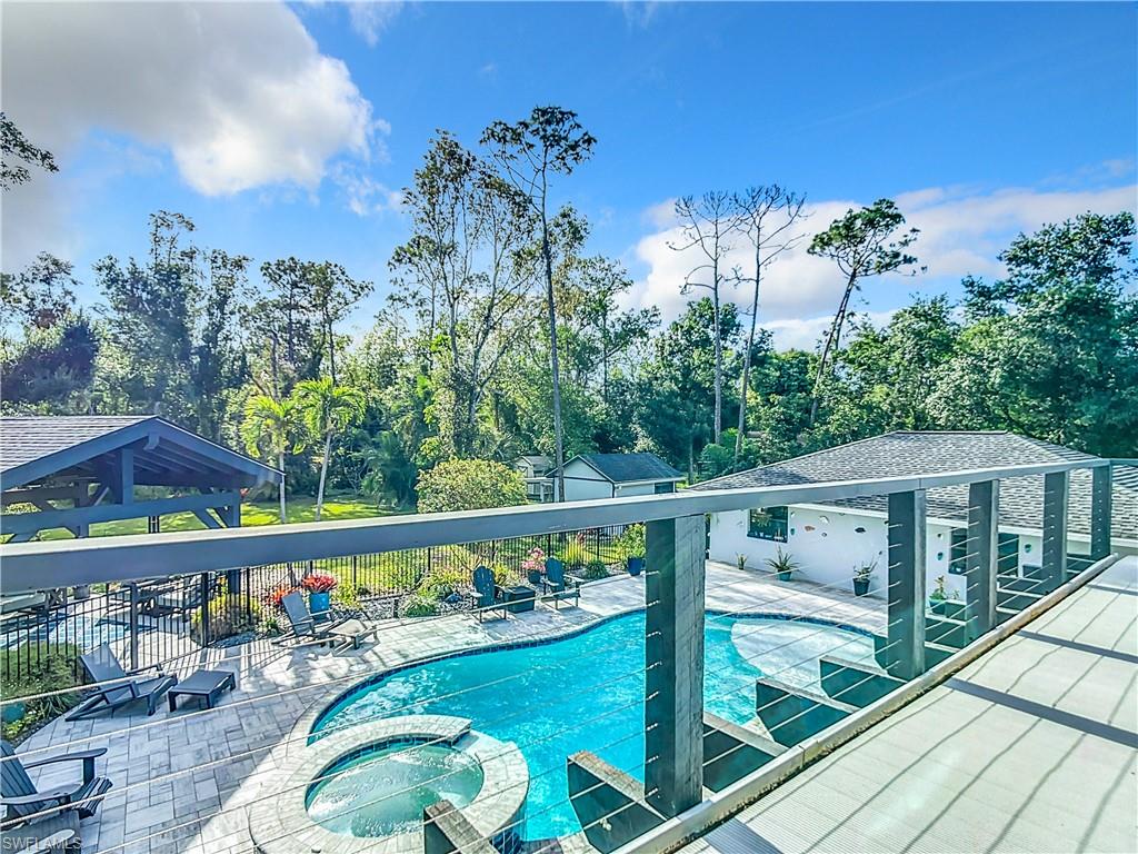 15711 Anderson Lane Fort Myers, FL 33912 - Photo 34 of 48 View of swimming pool with a pool with connected hot tub, view of wooded area, and a patio