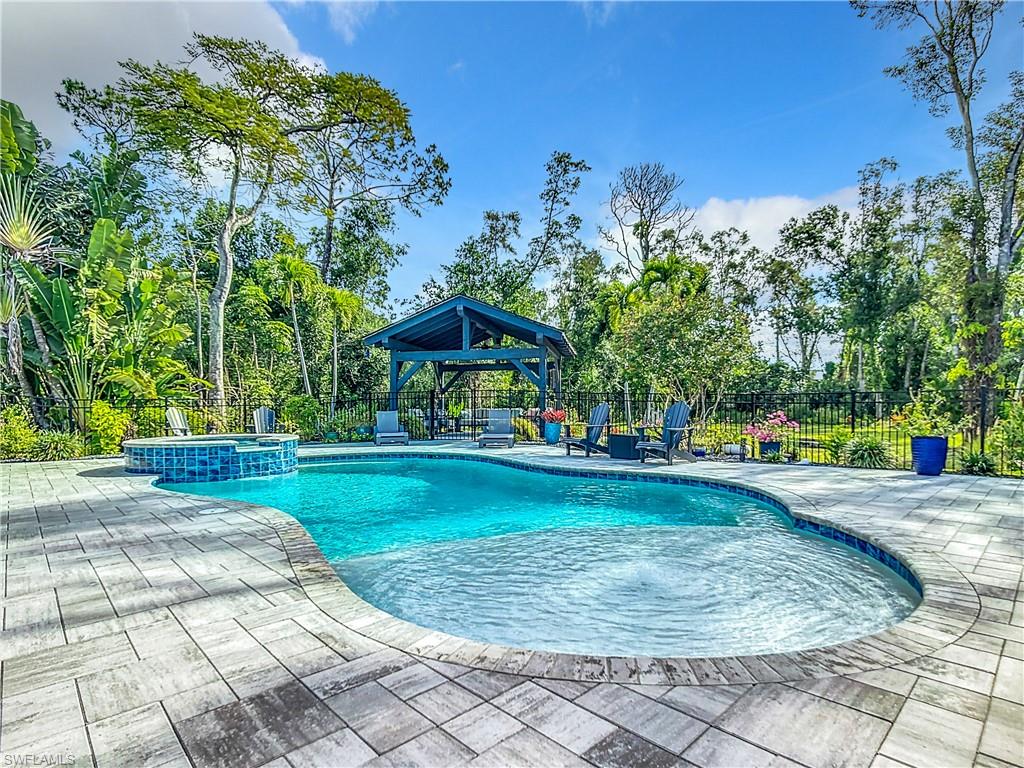 15711 Anderson Lane Fort Myers, FL 33912 - Photo 37 of 48 View of pool featuring a patio, a fenced backyard, and a pool with connected hot tub