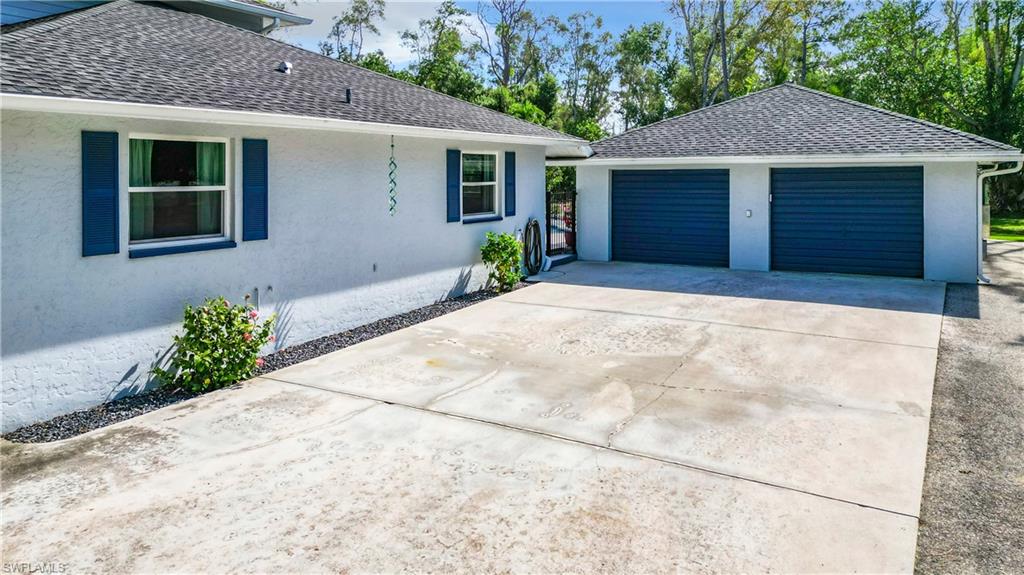 15711 Anderson Lane Fort Myers, FL 33912 - Photo 39 of 48 View of side of homegarages and large concrete driveway for ample parking