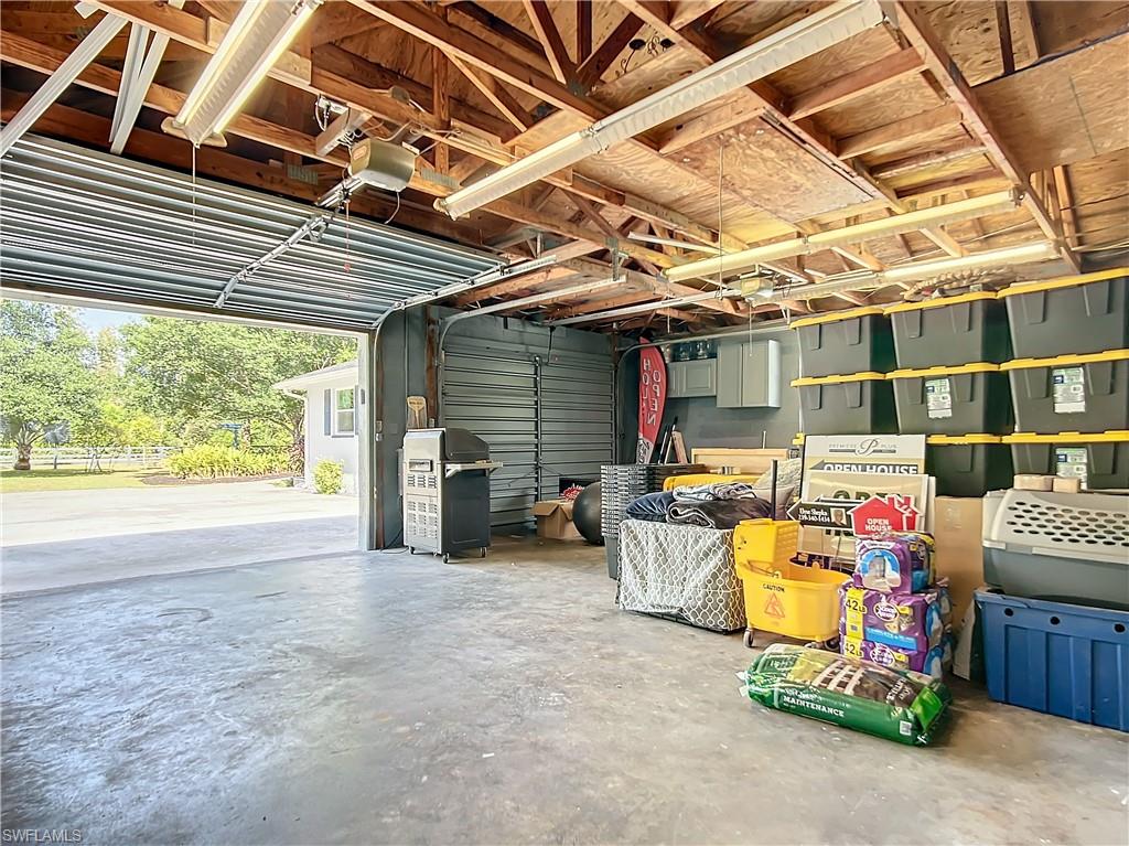 15711 Anderson Lane Fort Myers, FL 33912 - Photo 40 of 48 Garage featuring a garage door opener