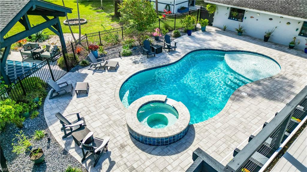 15711 Anderson Lane Fort Myers, FL 33912 - Photo 43 of 48 View of pool featuring a patio area, a pool with connected hot tub, and a fenced backyard