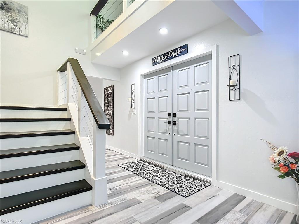 15711 Anderson Lane Fort Myers, FL 33912 - Photo 6 of 48 iInside entryway with light tile floors, stairs, and recessed lighting