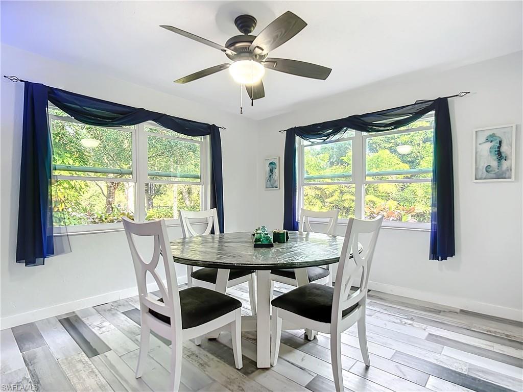 15711 Anderson Lane Fort Myers, FL 33912 - Photo 7 of 48 Diningroom featuring large windows for light airy dining and a designer ceiling fan
