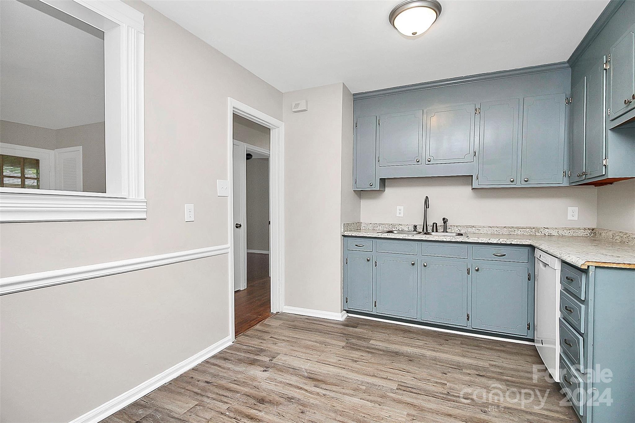 1120 Claremont Road Charlotte, NC 28214 - Photo 12 of 37 a view of a kitchen with wooden floor