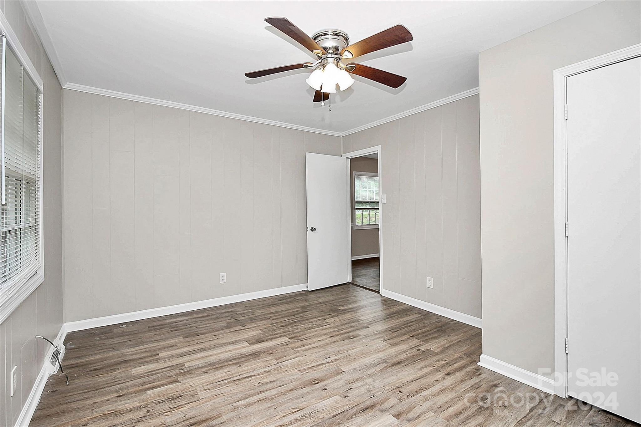 1120 Claremont Road Charlotte, NC 28214 - Photo 15 of 37 an empty room with wooden floor and ceiling fan