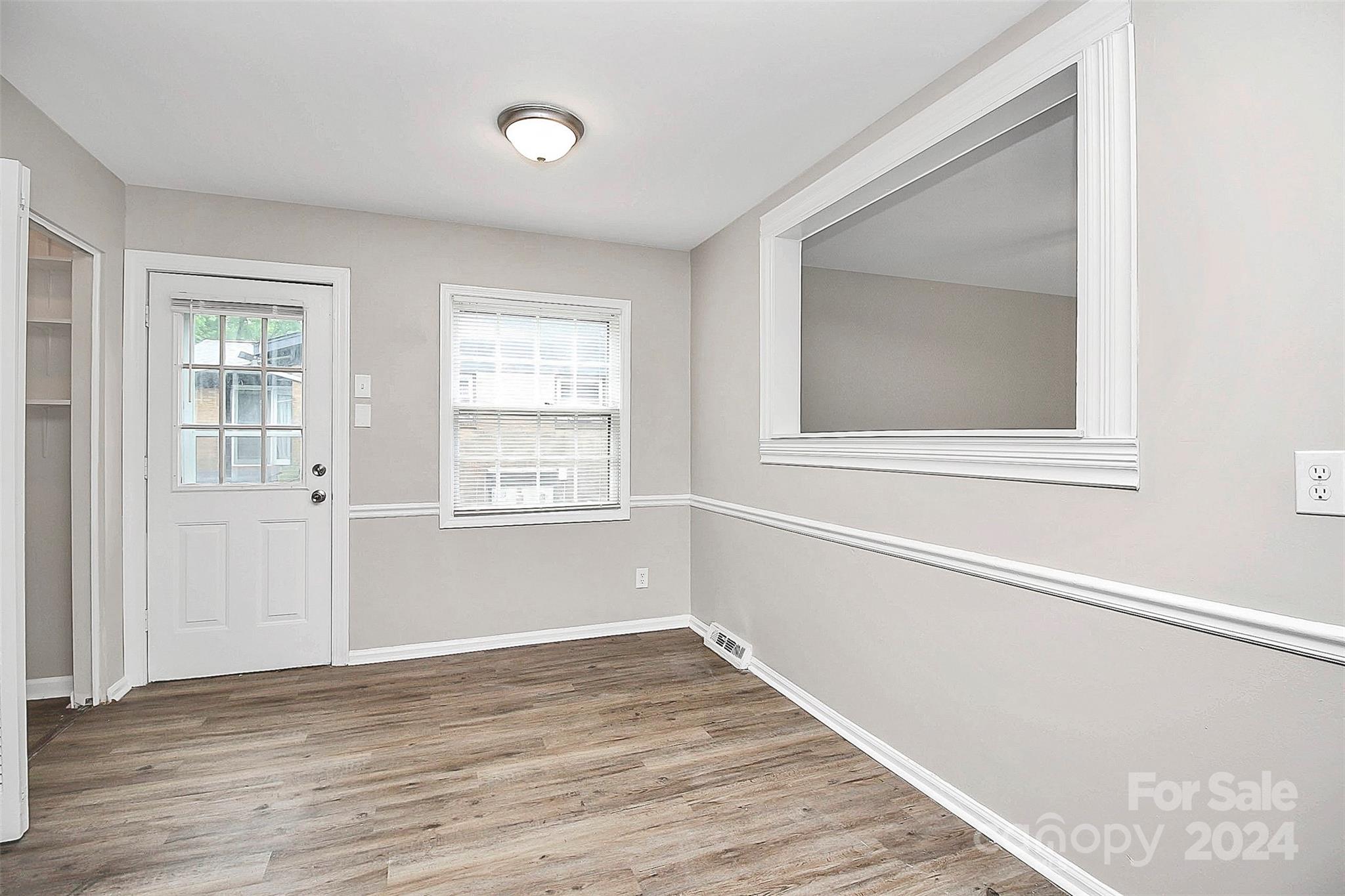 1120 Claremont Road Charlotte, NC 28214 - Photo 17 of 37 a view of an empty room with wooden floor and a window