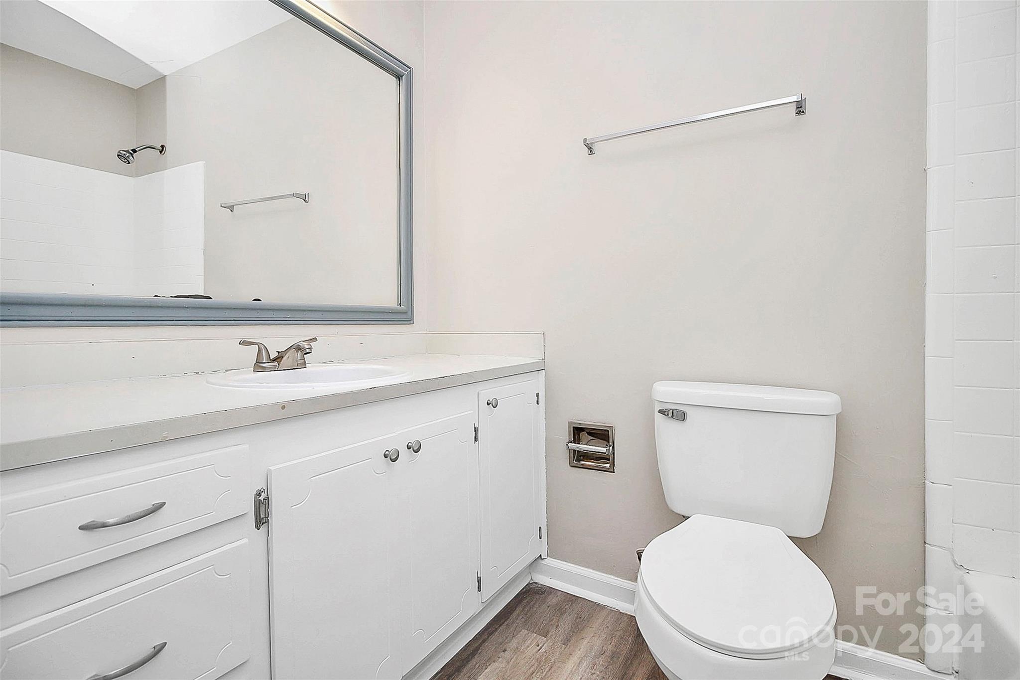 1120 Claremont Road Charlotte, NC 28214 - Photo 18 of 37 a bathroom with a toilet sink and mirror
