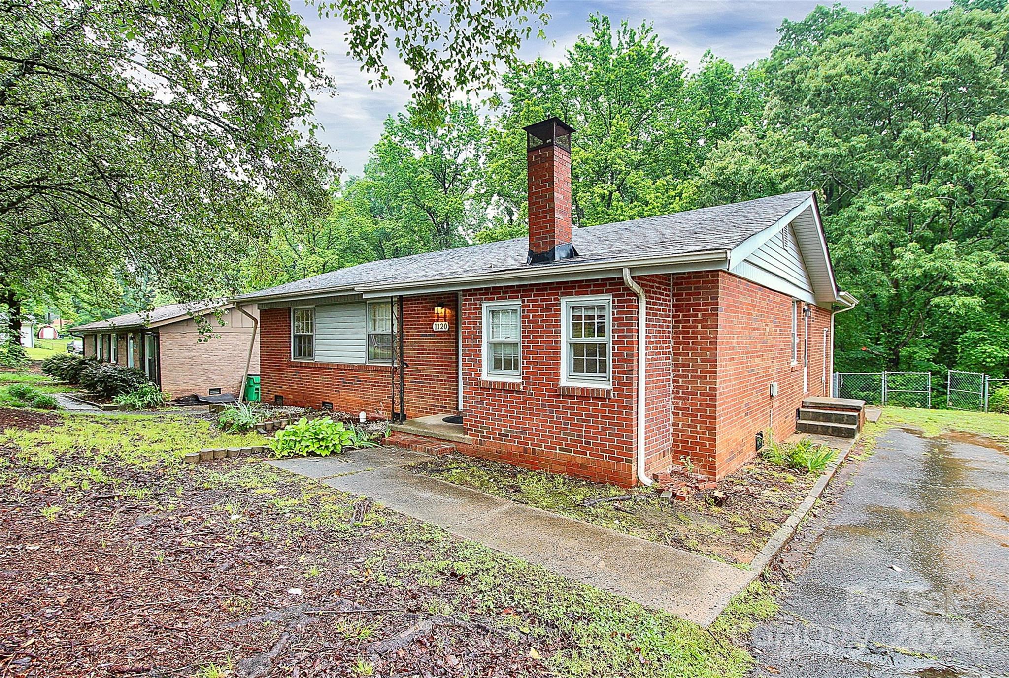 1120 Claremont Road Charlotte, NC 28214 - Photo 2 of 37 a front view of a house with garden