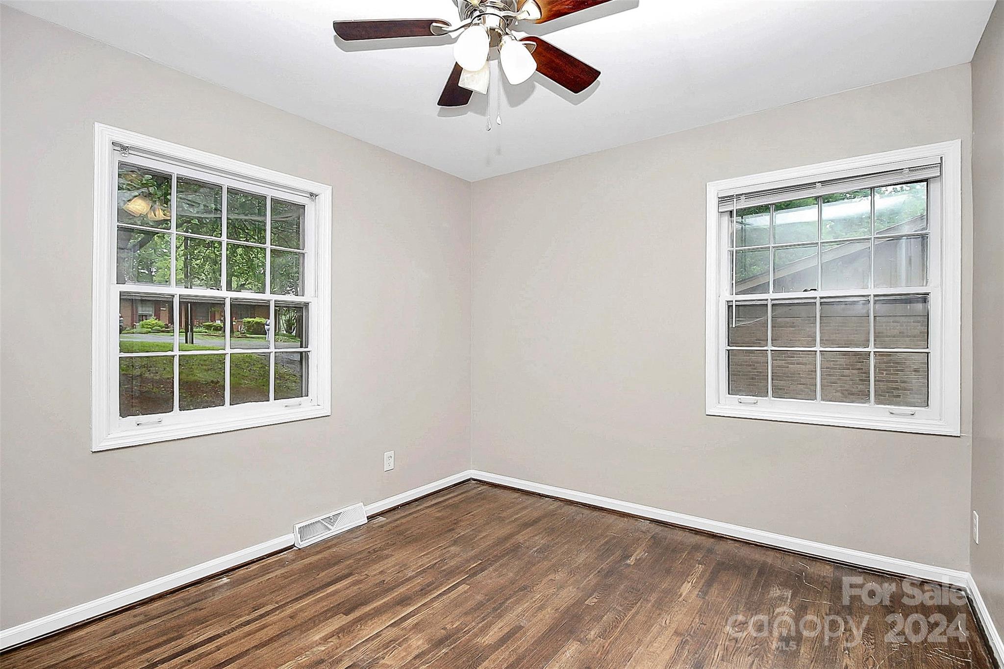 1120 Claremont Road Charlotte, NC 28214 - Photo 24 of 37 an empty room with a window and wooden floor