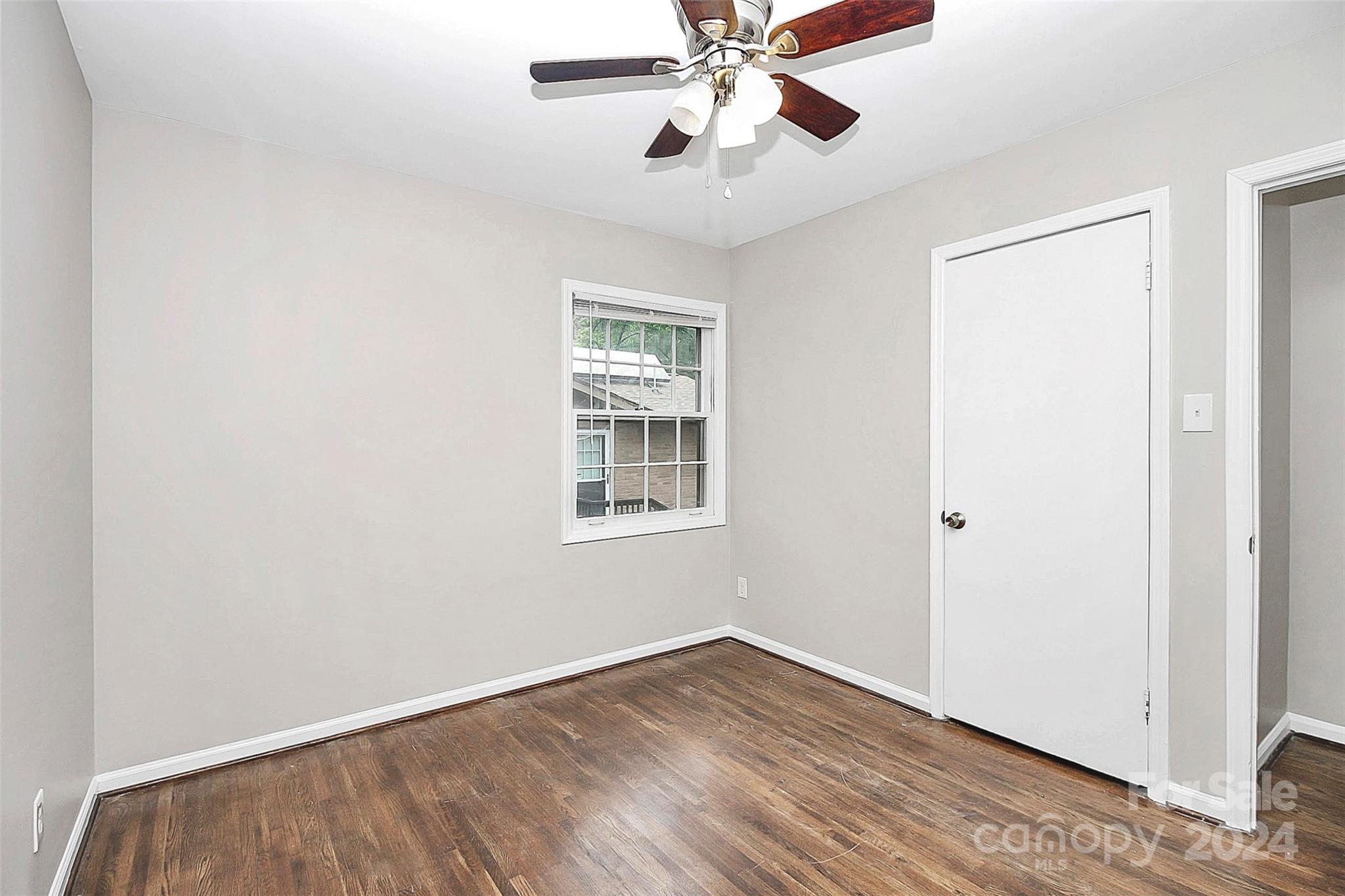 1120 Claremont Road Charlotte, NC 28214 - Photo 25 of 37 a view of an empty room with wooden floor and a window