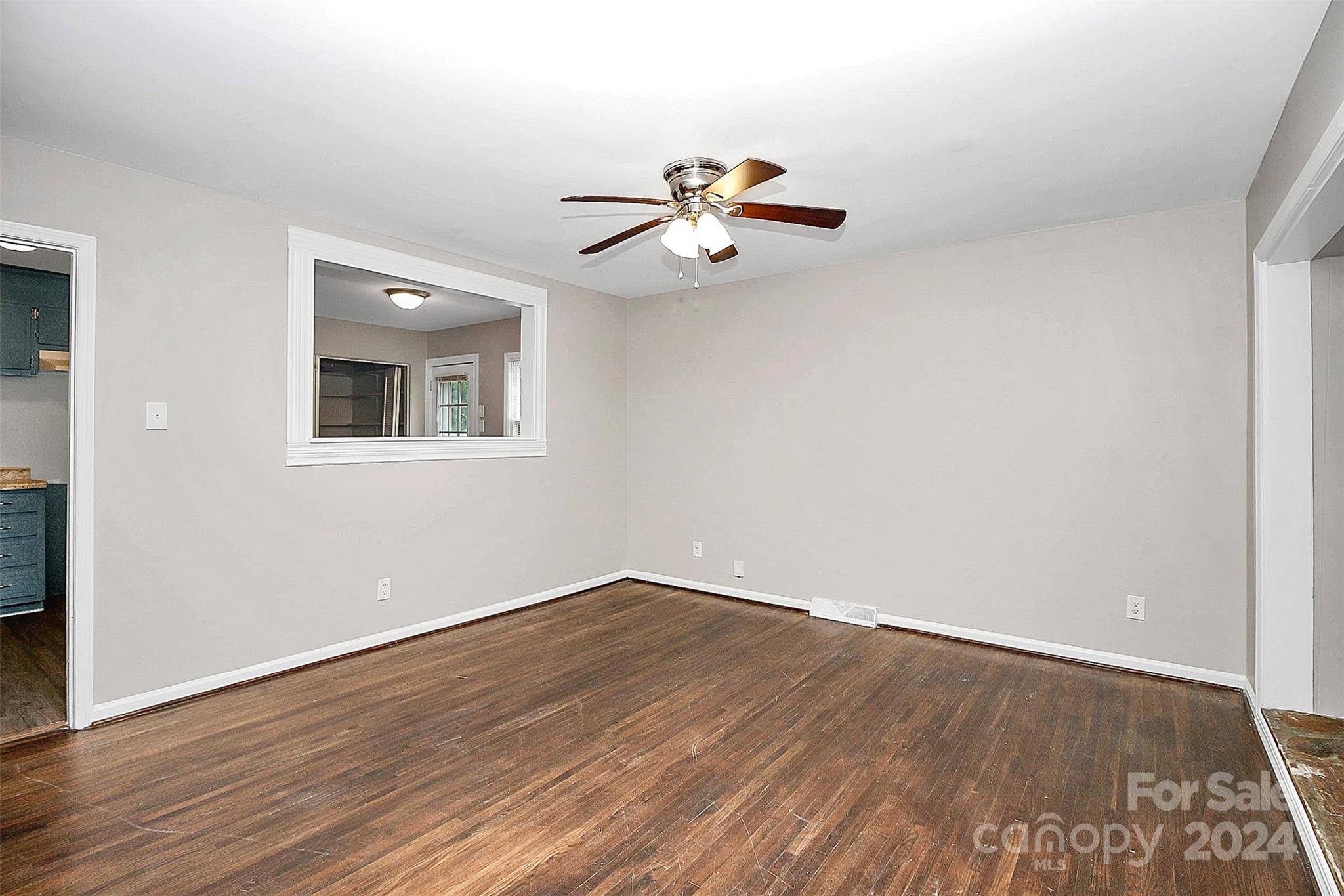 1120 Claremont Road Charlotte, NC 28214 - Photo 3 of 37 a view of a room with wooden floor and ceiling fan