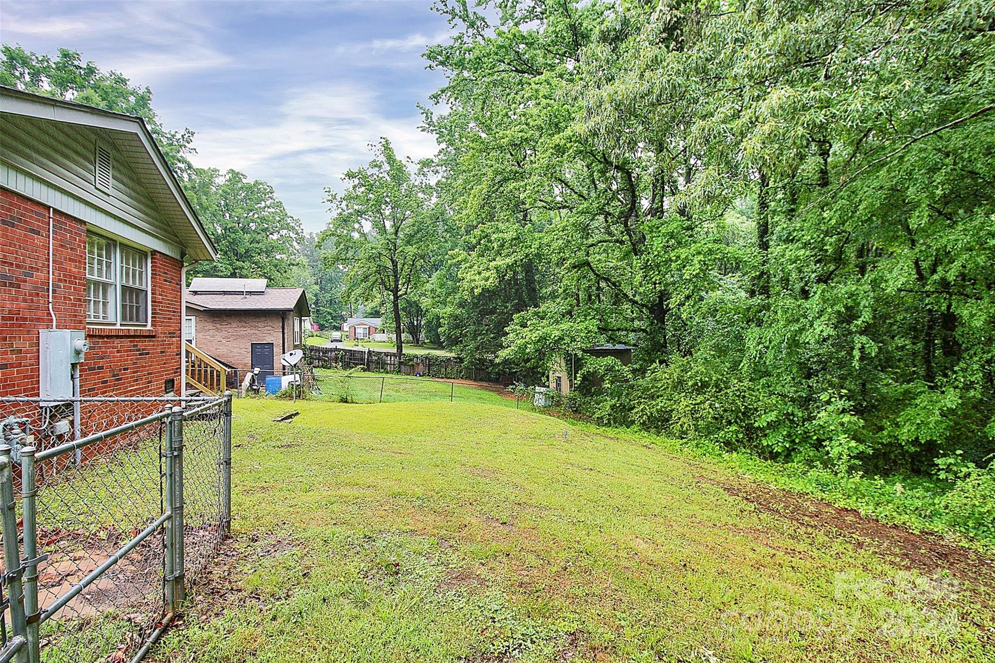1120 Claremont Road Charlotte, NC 28214 - Photo 31 of 37 a view of a house with pool and a yard