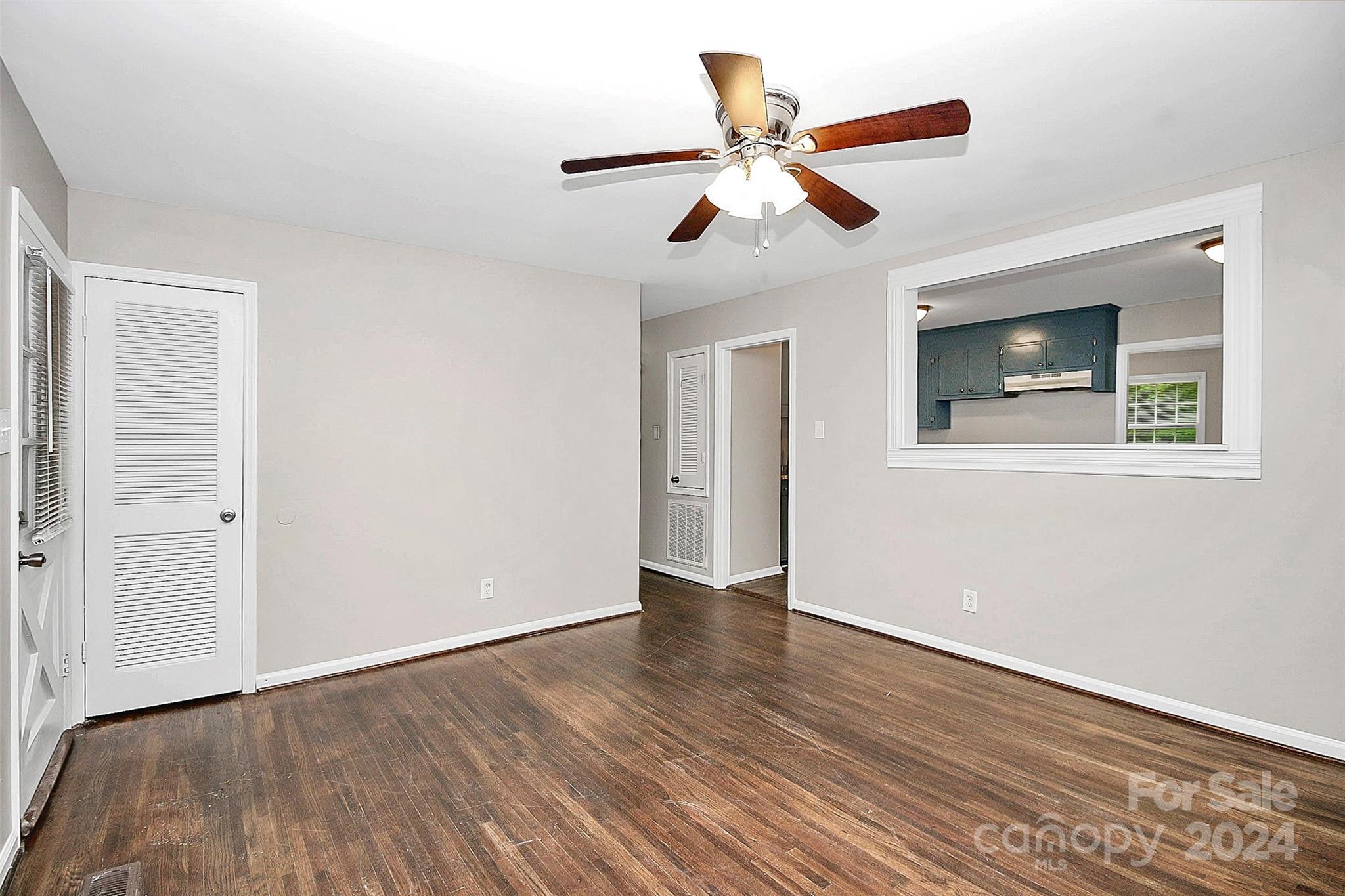 1120 Claremont Road Charlotte, NC 28214 - Photo 4 of 37 a view of an empty room with wooden floor and a ceiling fan