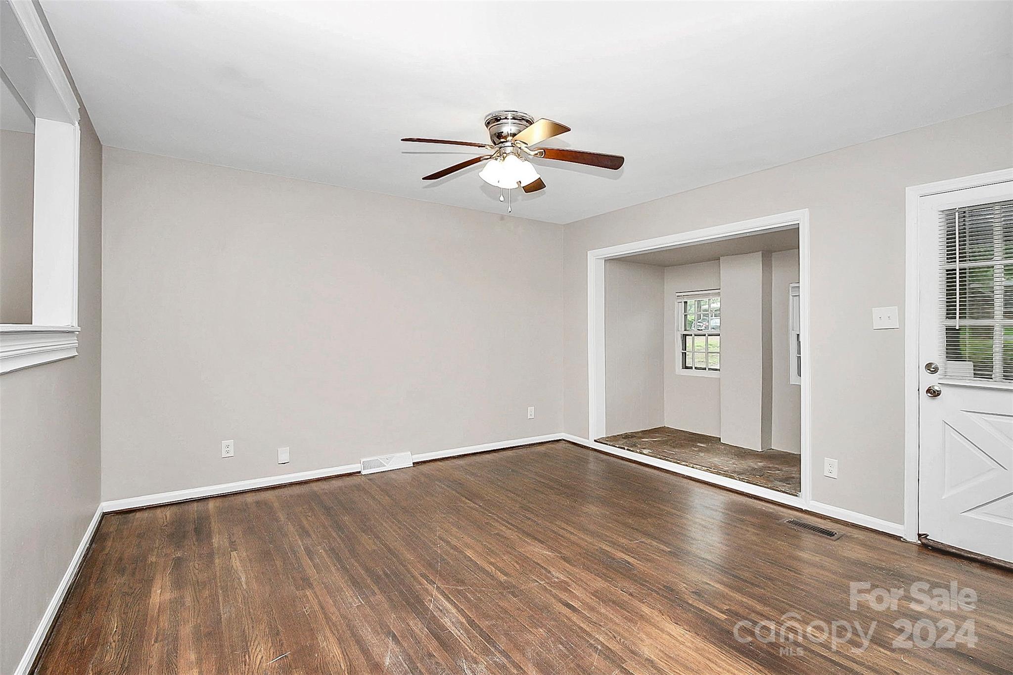 1120 Claremont Road Charlotte, NC 28214 - Photo 6 of 37 wooden floor in an empty room with a window