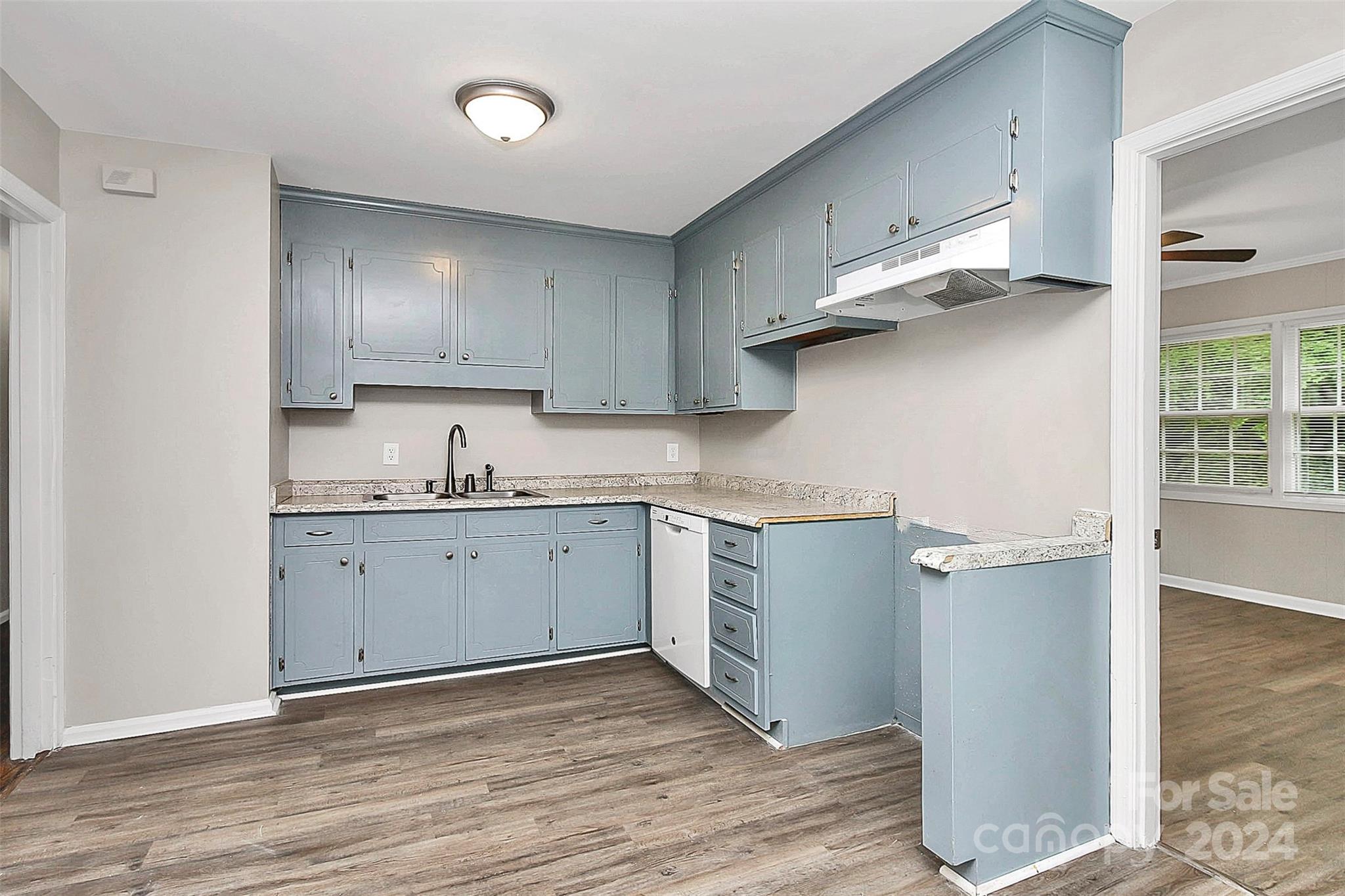 1120 Claremont Road Charlotte, NC 28214 - Photo 9 of 37 a kitchen with cabinets appliances and a wooden floor