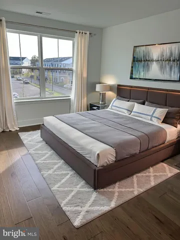 a bedroom with a large bed and a large window