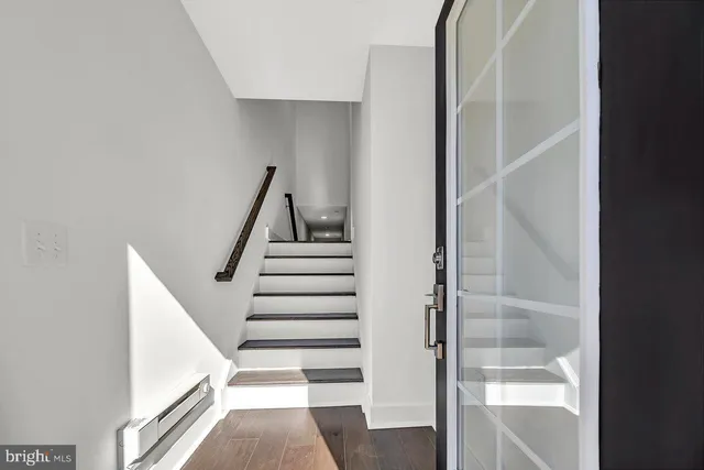 a view of staircase with white walls and windows