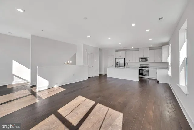 a view of kitchen with cabinets and wooden floor