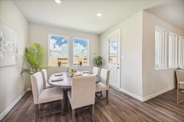 a view of a dining room with furniture windows and wooden floor