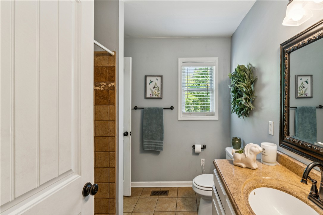 189 Little Choestoea Road Westminster, SC 29693 - Photo 22 of 38 This bathroom features a single vanity, a toilet, and a tiled shower for daily comfort.