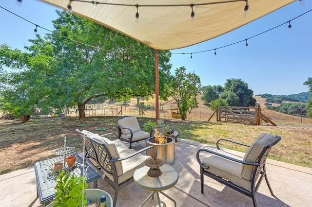 a view of a house with swimming pool and sitting area