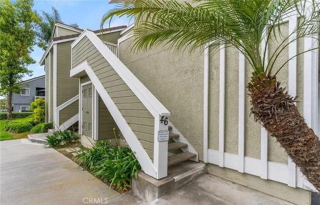 a view of a house with a palm tree