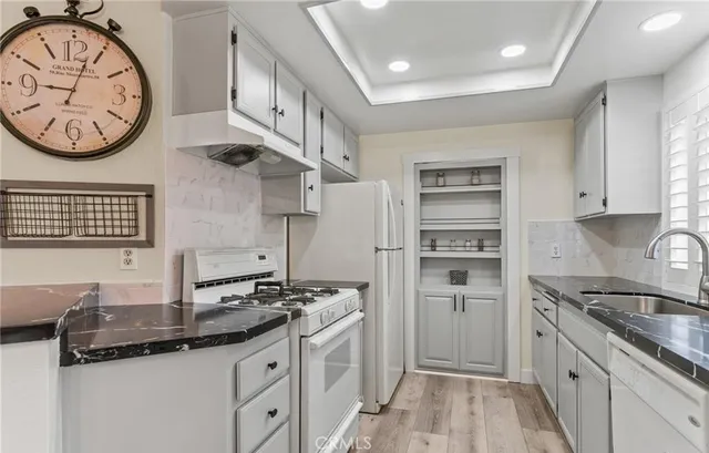 a kitchen with stainless steel appliances granite countertop a sink and a stove