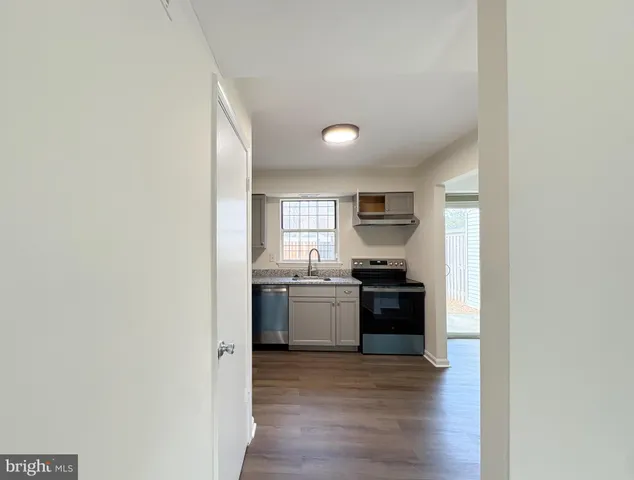 a kitchen with a refrigerator and a stove top oven