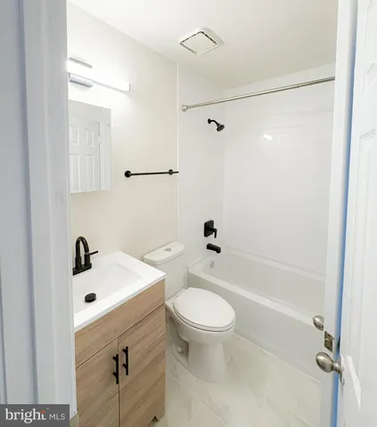 a bathroom with a sink mirror bathtub and toilet