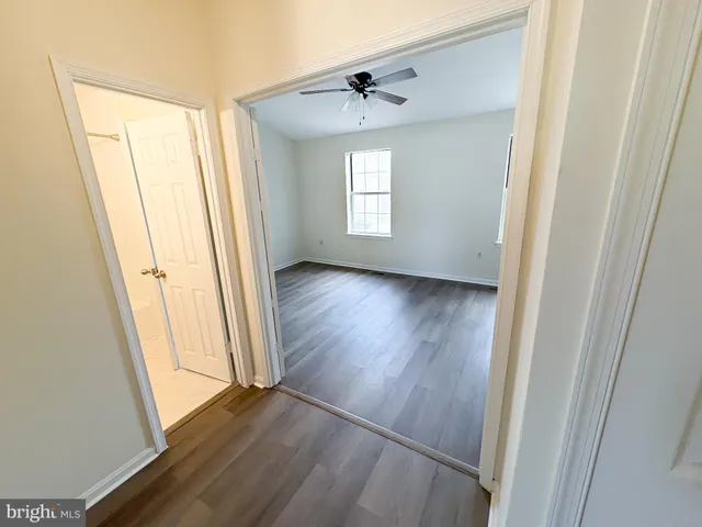 an empty room with wooden floor and a window