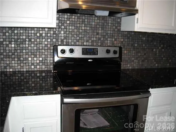 a close view of a stove a microwave and cabinets