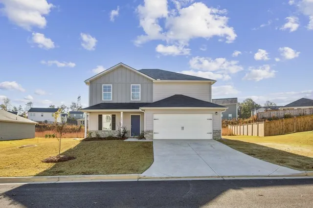 a front view of a house with a yard