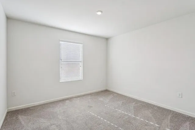 a bathroom with a granite countertop bathtub shower sink vanity mirror and toilet