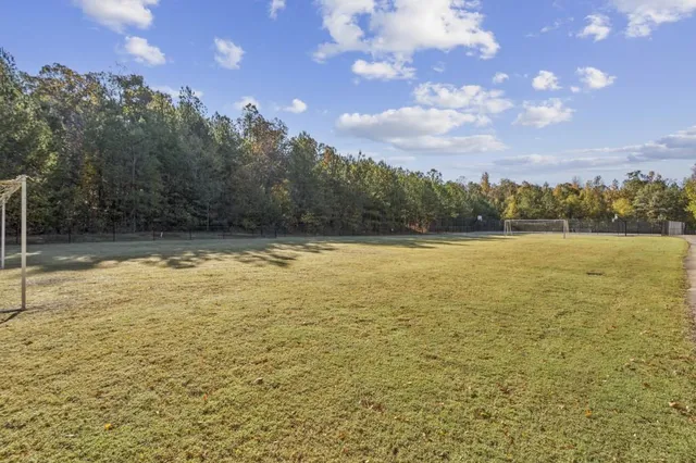 a front view of a house with a yard and outdoor seating