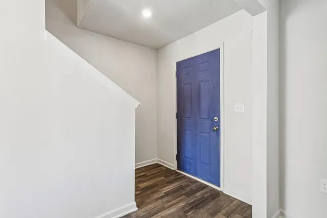 a view of hallway with wooden floor